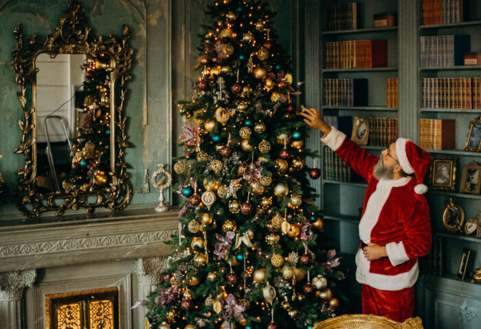 Santa trimming a Christmas Tree
