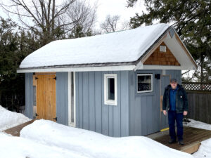 Pictured here is London Hoft outside his custom-designed and personally built backyard shed with its clean lines and inviting exterior and an interior that features room for storage, tools and a sauna. Photo: Liza Fendt