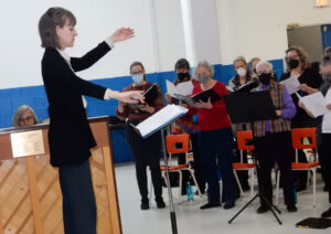 Seen leading a rehearsal for the March 19th production of Composed by Women: Music of War and Peace is Dr. Gabrielle Gaudreault, Ottawa Choral Society Artistic Director and Conductor and Scott Richardson, accompanist (in the background). Photo: Sharleen Tattersfield