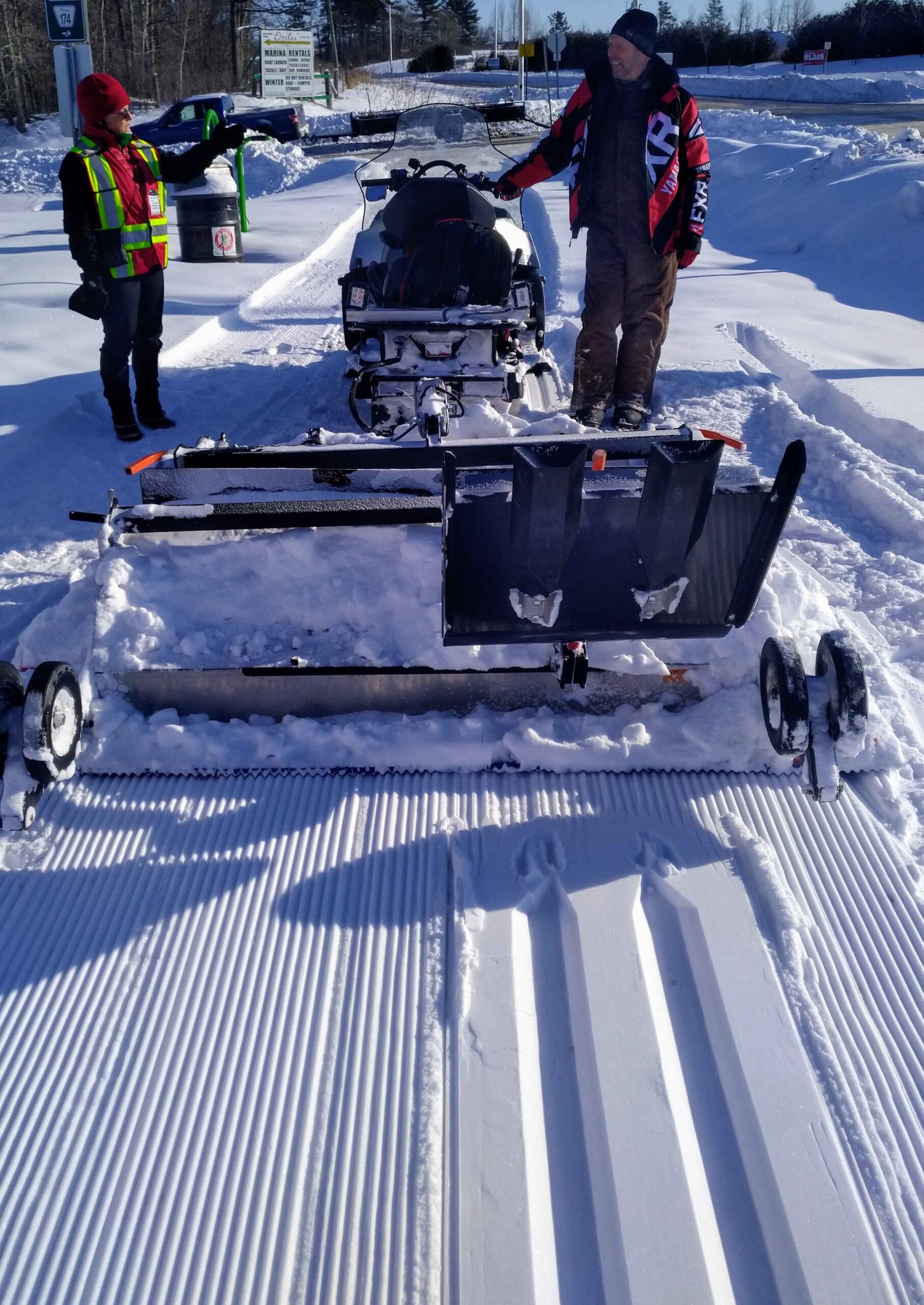In 2021, Ski Heritage East Head Groomer Lyle Fair (right) works the Ginzu Groomer being towed by a Yahama snowmobile. (The group acquired a second Ginzu in 2022.) Photo supplied by Ski Heritage East