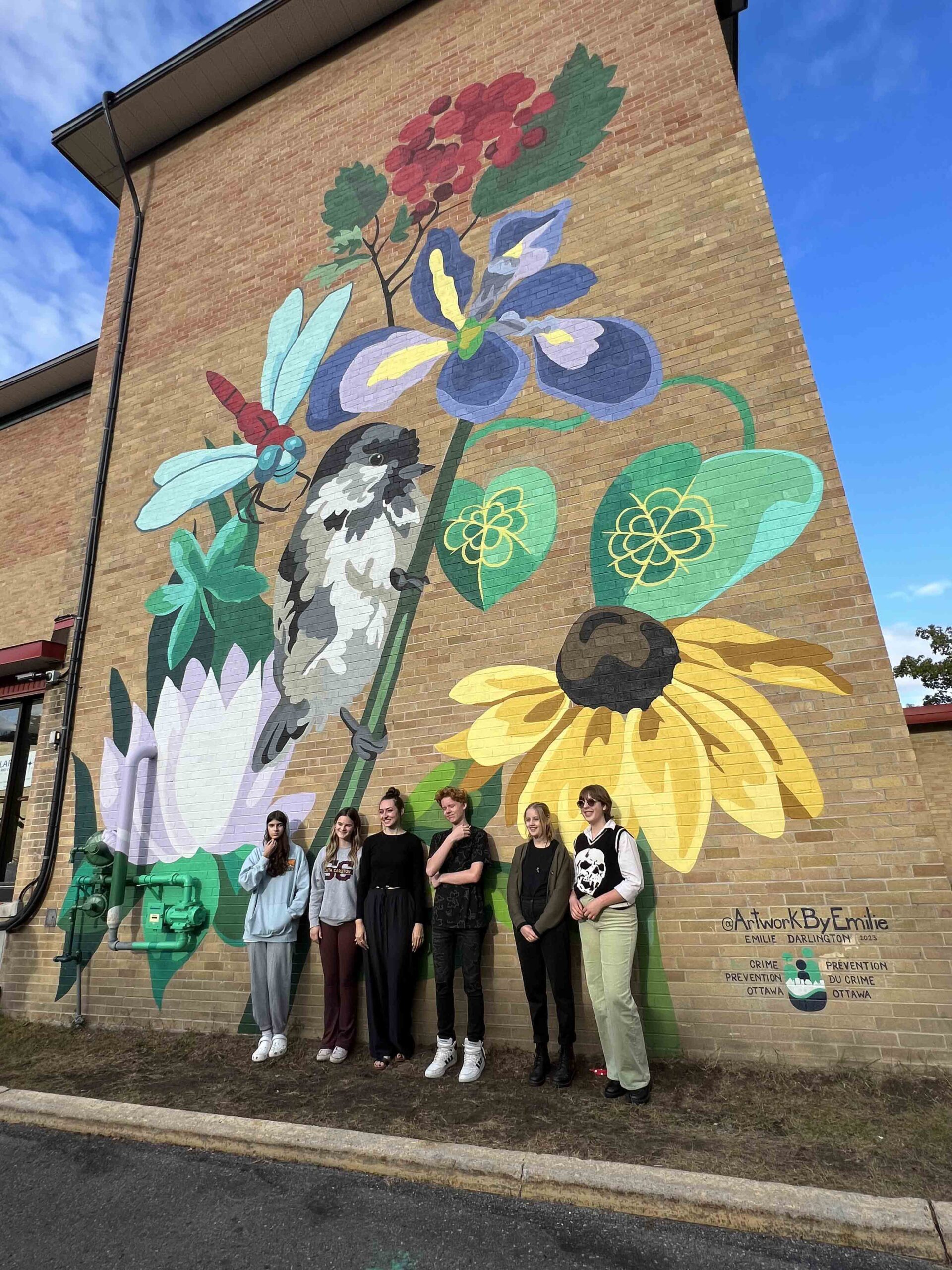 The new, three-story mural at 1805 Gaspé Ave. was unveiled in September. It was created by Ottawa muralist Emilie Darlington (third from left) and local youth artists. From left to right, Maya Cultrera, Caitlyn Groleau, Emilie, Lewis Punnett Clarkson, Grace Renton and Jori Pouling. Also involved, though not pictured, are Serena Sass, Alicia Regis and Lily Fleur Marks. Photo supplied