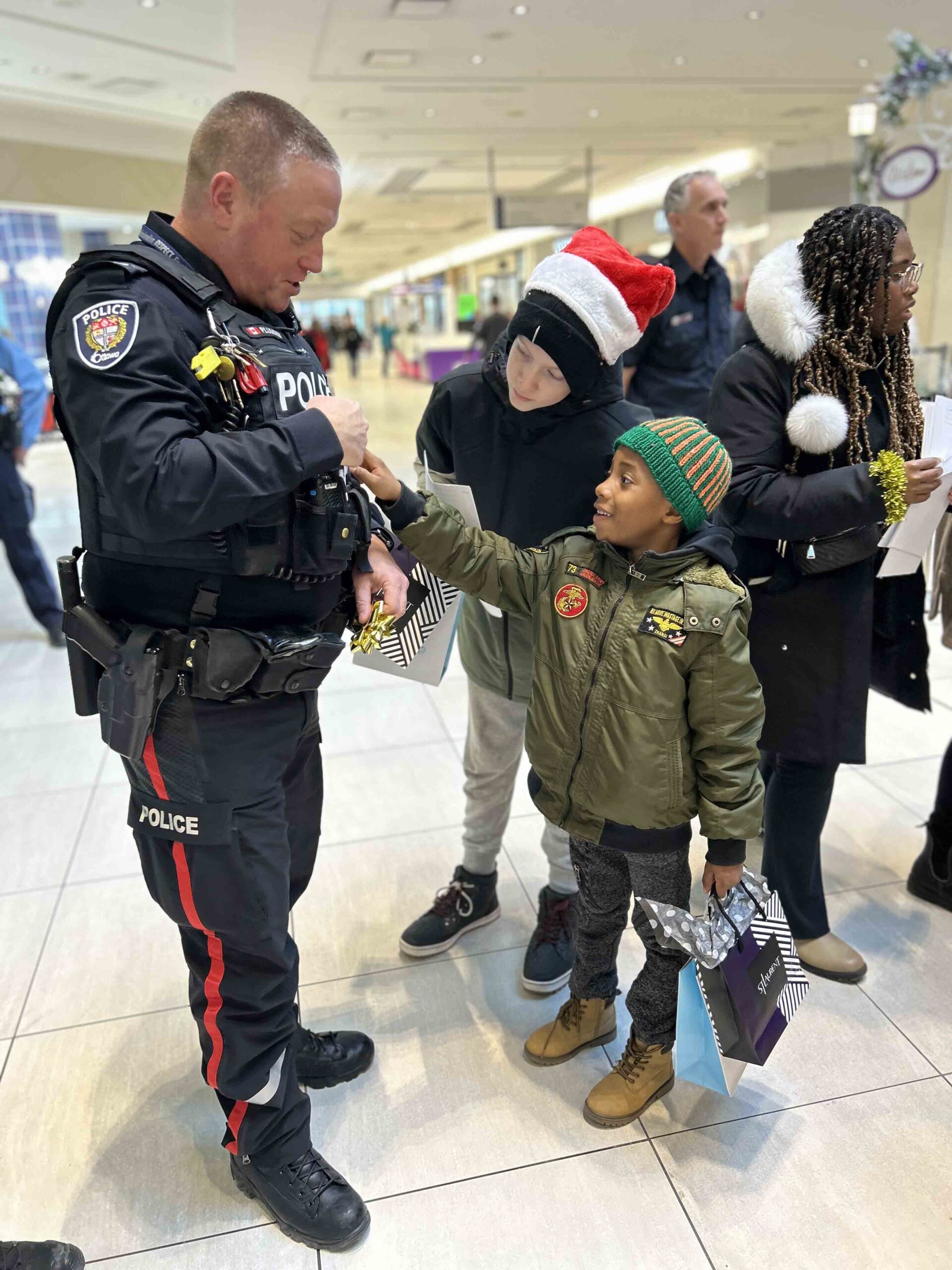 Shop With Your Hero participant Ottawa Police Services Sgt. Stephen Plummer was among the first responders who brought kids on a ride in a police cruiser for some holiday shopping at the St. Laurent Shopping Centre. Photo supplied