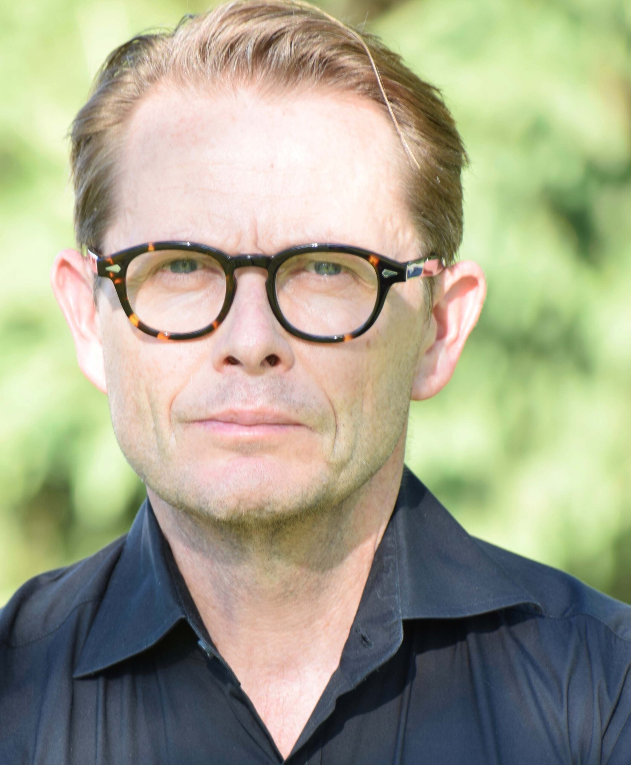 Headshot of author John Delacourt