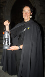 Haunted Walk guide Kathryn Lyons holds up a lantern to help guide visitors through the Beechwood Cemetery. PHOTO: Ryland Coyne