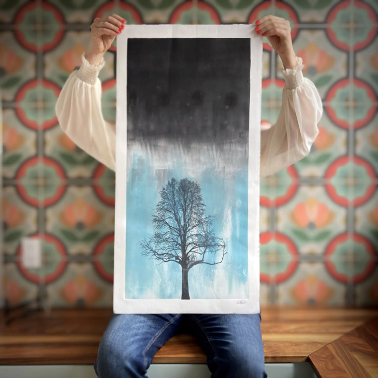 Artist and Manor Park resident Sarah Hallman holds up one of her stunning prints. PHOTO: Submitted
