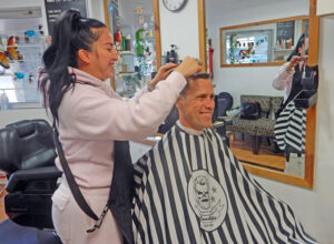 Shown getting a trim at the Manor Park Barber Shop (Rockcliffe Crossing Plaza) by barbershop owner Laura Goyos is Manor Park resident Ryan Davidson. PHOTO: SHARLEEN TATTERSFIELD