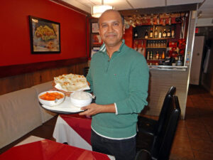 Pictured here with a palate warming platter of butter chicken, fresh naan and rice is Musharraf Miah owner/chef of Mia’s Indian Cuisine-St. Laurent. PHOTO: SHARLEEN TATTERSFIELD