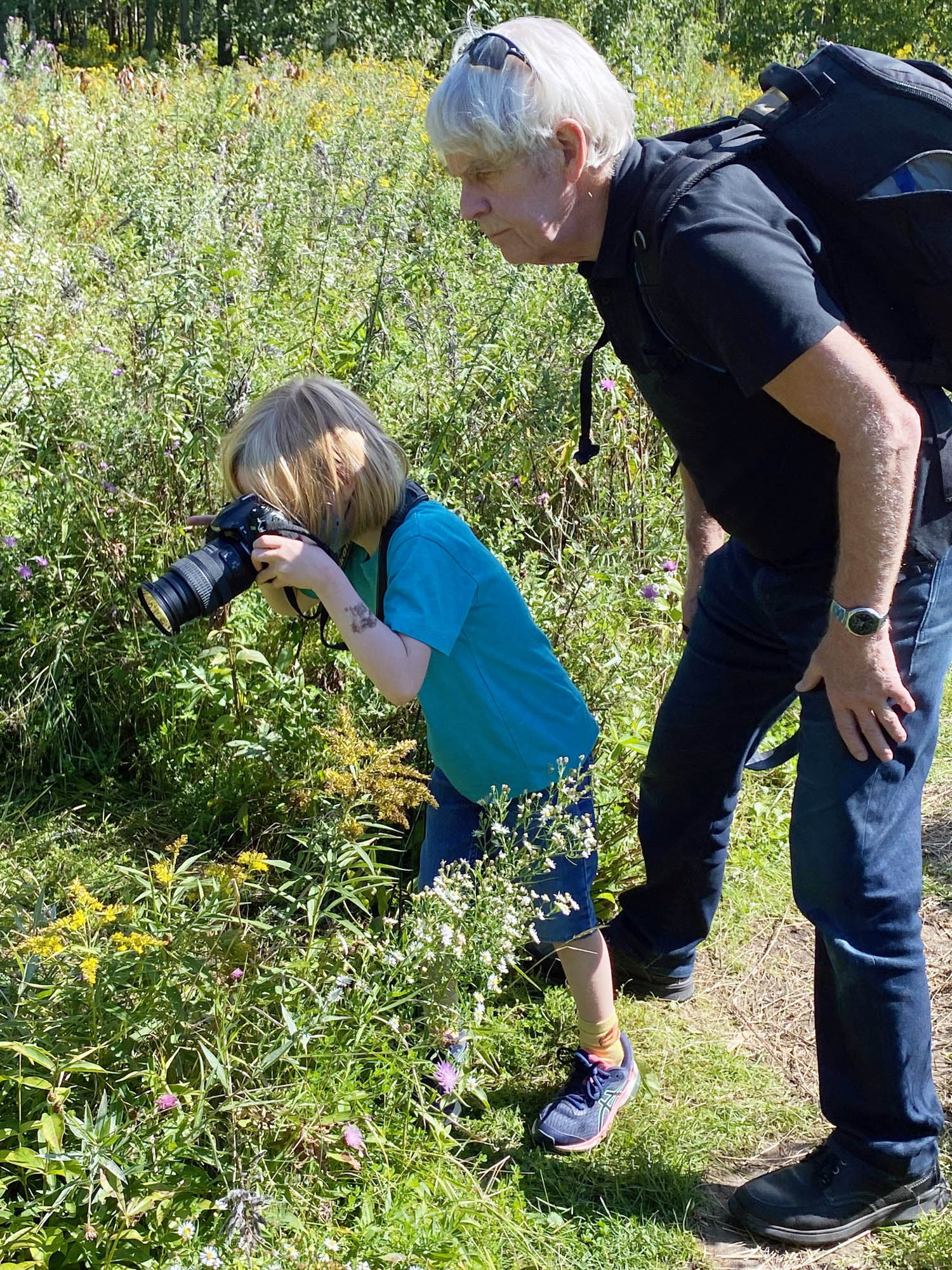 Dave Keys offers some photography advice to grandson Louis. PHOTO: SUBMITTED