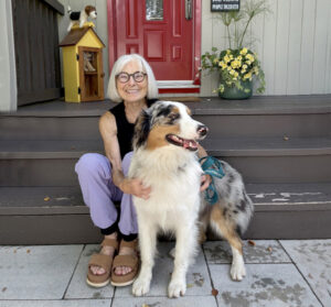 Manor Park is home to DOWNdog Yoga on Bedford Crescent, now celebrating its 10th year in business. Congratulations to owner and yoga teacher Jocelyne Campbell pictured here on her front steps with Dr. Maxi, her Aussie Shepherd mentor-in-training. PHOTO: COURTESY OF JOCELYNE CAMPBELL